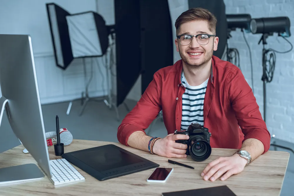 happy-freelancer-man-sitting-by-working-table-with-2024-11-18-13-54-34-utc